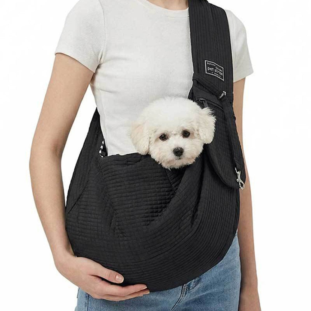 Black sling worn with a small white dog