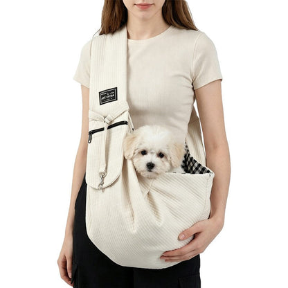 Rice white sling worn with a small dog
