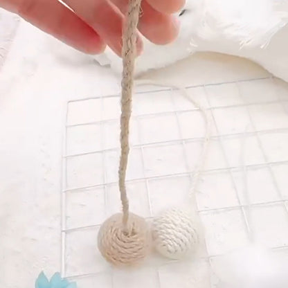 Sisal ball toy dangling from its cord