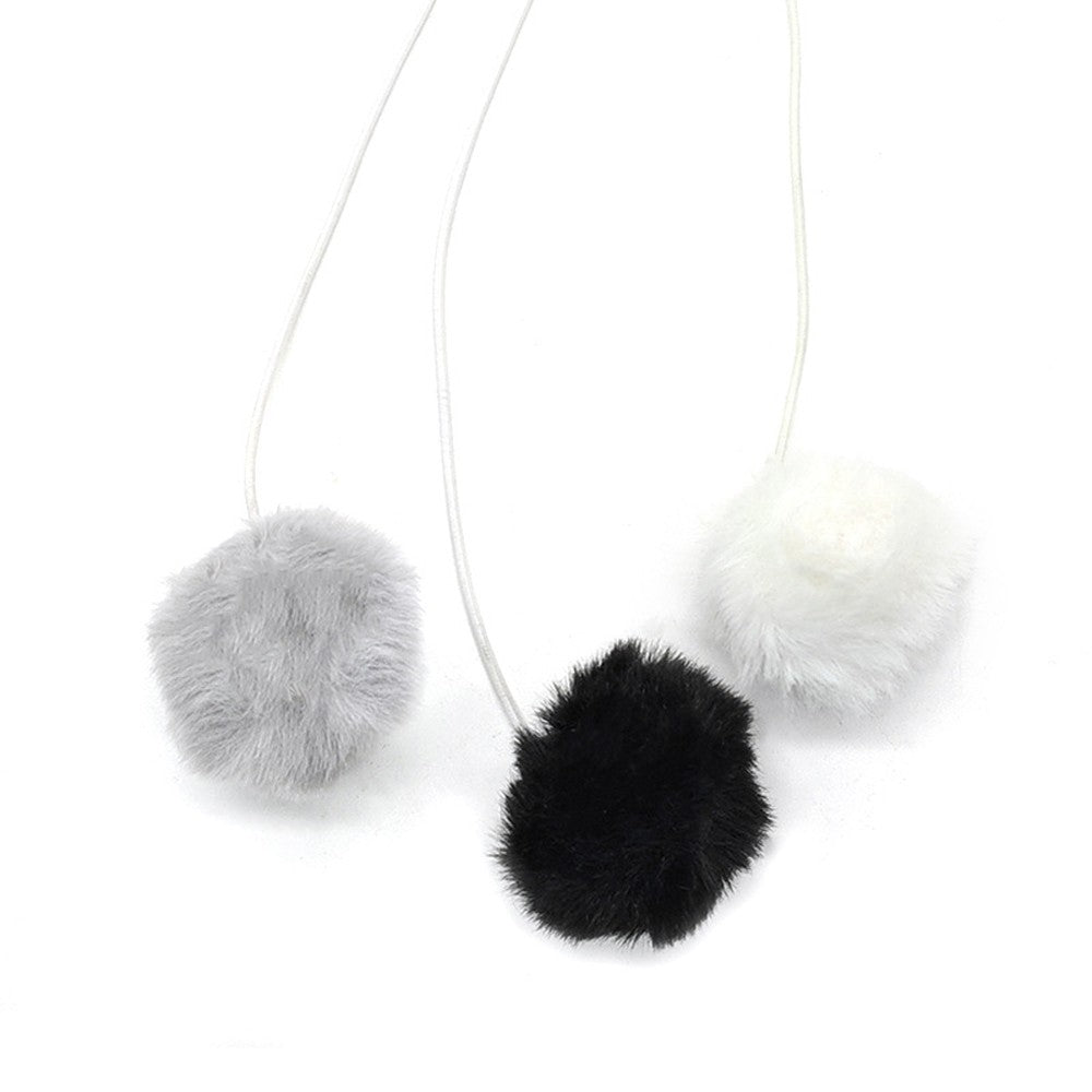 Fluffy pom-pom balls hanging from elastic cords