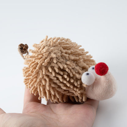 Hedgehog cat toy in the palm of a hand
