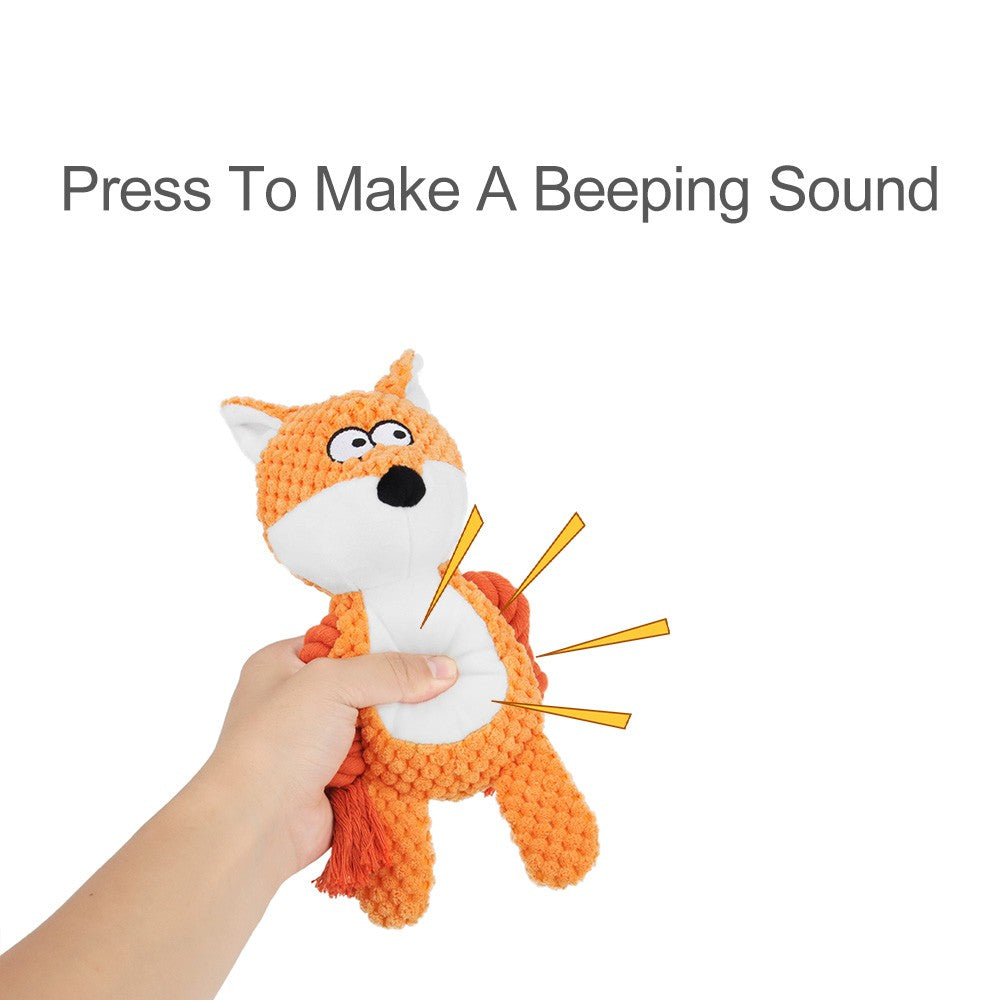 Hand squeezing the fox plush dog toy to make it squeak