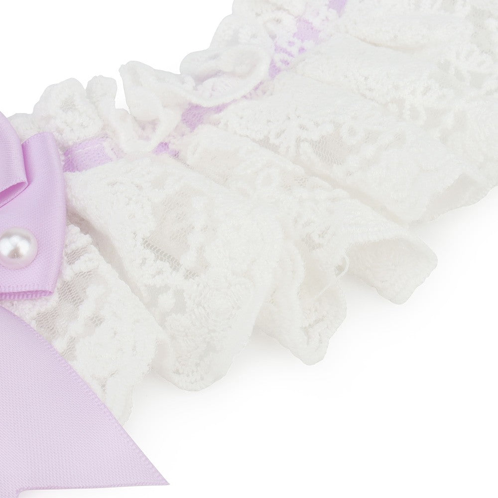 Close-up of the soft white lace edge on the bow collar