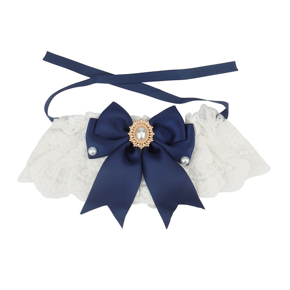 Navy satin bow on a white lace bow cat collar with ribbon ties