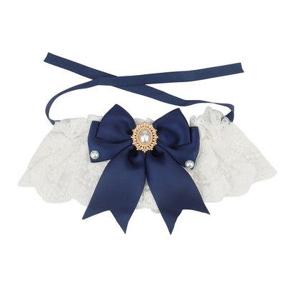 Navy satin bow on a white lace bow cat collar with ribbon ties