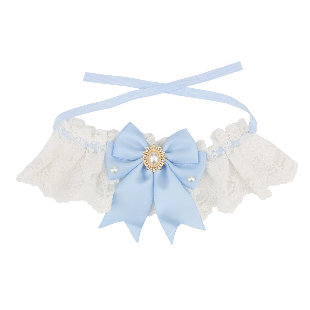 Light blue satin bow on a white lace bow cat collar