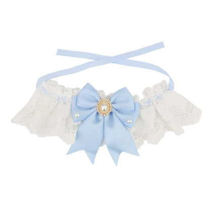 Light blue satin bow on a white lace bow cat collar