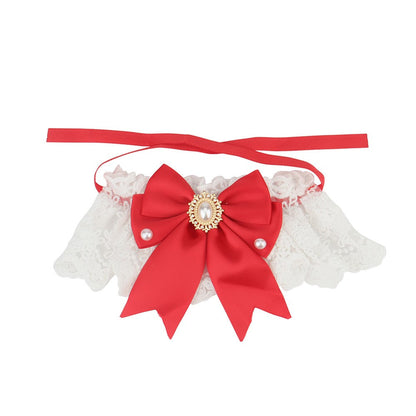 Red satin bow on a white lace bow cat collar