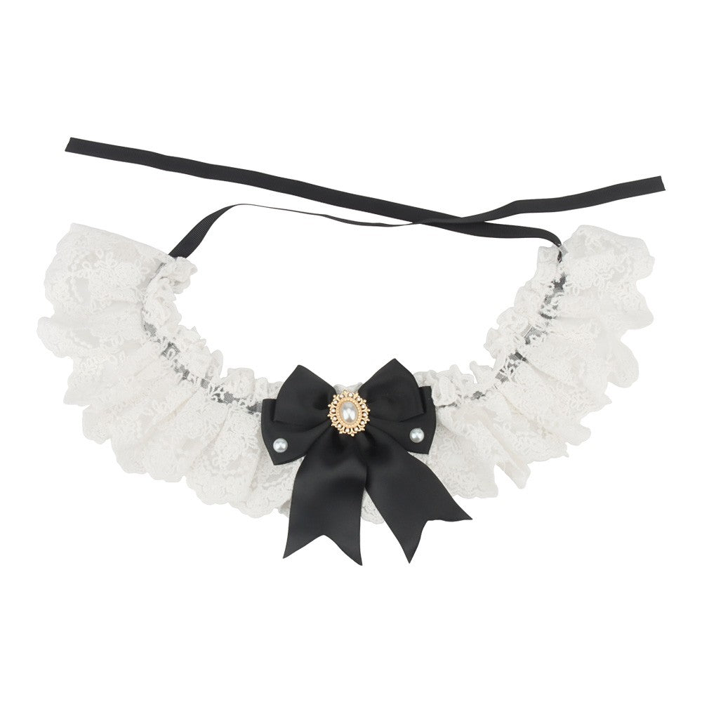 Black satin bow on a white lace bow cat collar with black ribbon