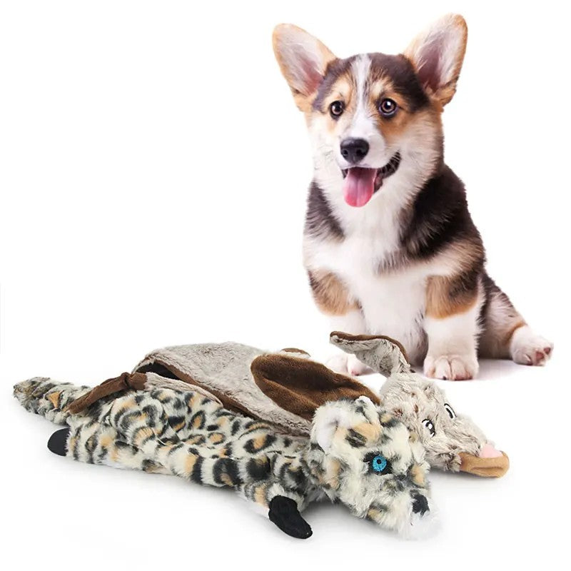 Corgi lying with snow leopard plush dog toys