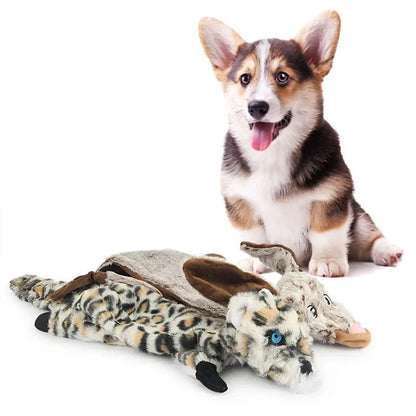 Corgi lying with snow leopard plush dog toys