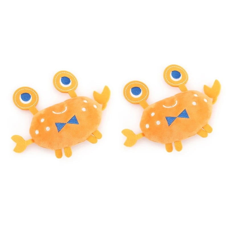 Two orange crab dog toys with blue bow ties