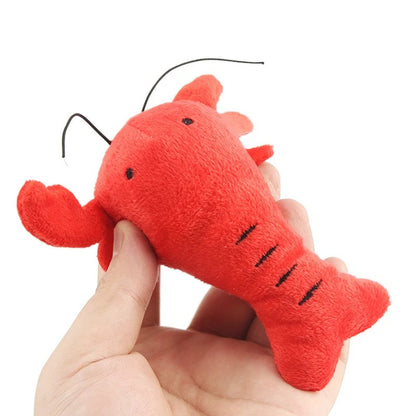 Hand holding the red lobster plush toy