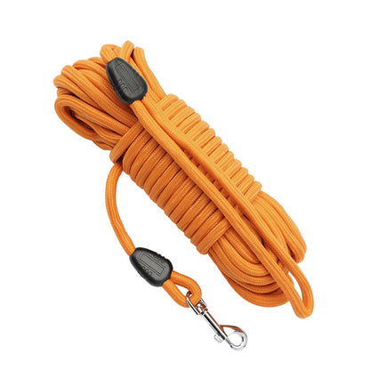 Orange long line dog leash coiled with loop handle