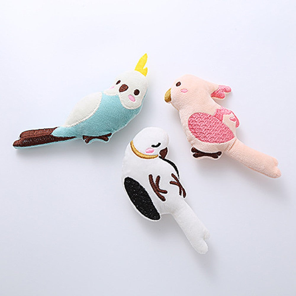 Three plush parrot cat toys in blue, pink and white