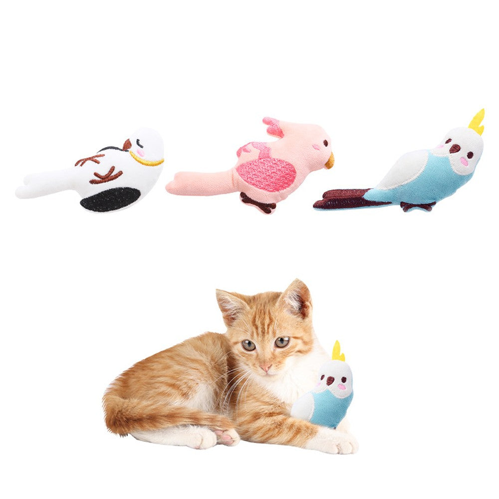 Kitten lying next to a blue plush parrot cat toy