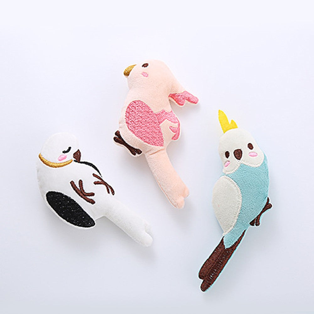 Three catnip bird cat toys laid out together