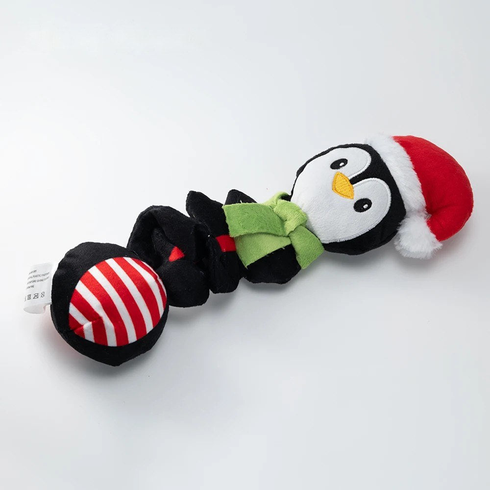 Penguin dog toy in black with red hat, green scarf and striped ball end