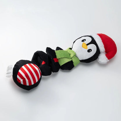 Penguin dog toy in black with red hat, green scarf and striped ball end