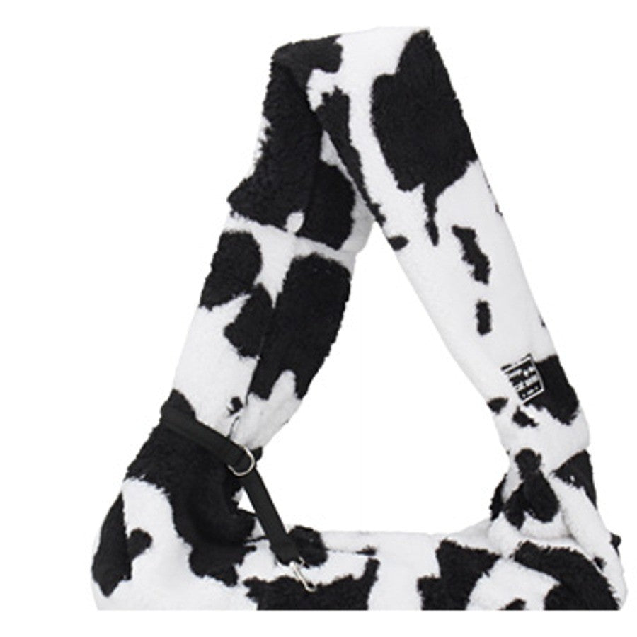 Plush pet carrier bag hanging to show the adjustable strap and safety clip