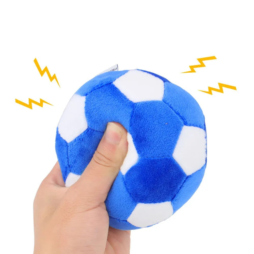Hand squeezing the plush ball to sound the built-in squeaker