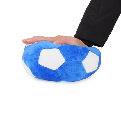 Hand pressing down on the soft plush ball