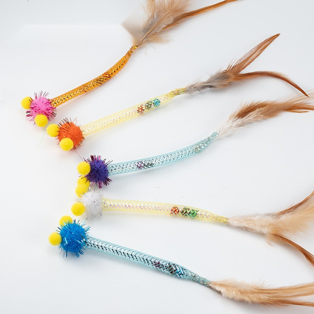Pom-pom cat toys in pink, orange, purple, white and blue