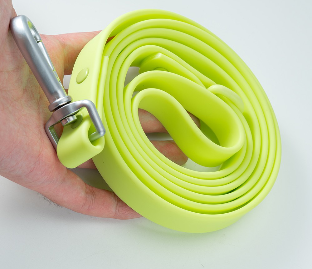 Lime PVC dog leash held in a hand