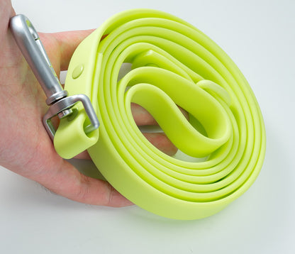 Lime PVC dog leash held in a hand