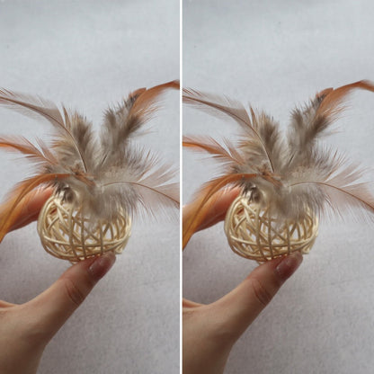 Two beige rattan balls with feathers