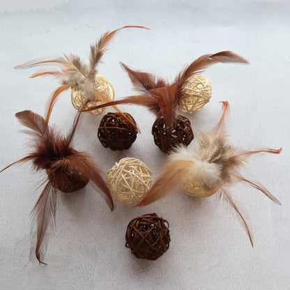 Rattan balls and feathers scattered on a white surface
