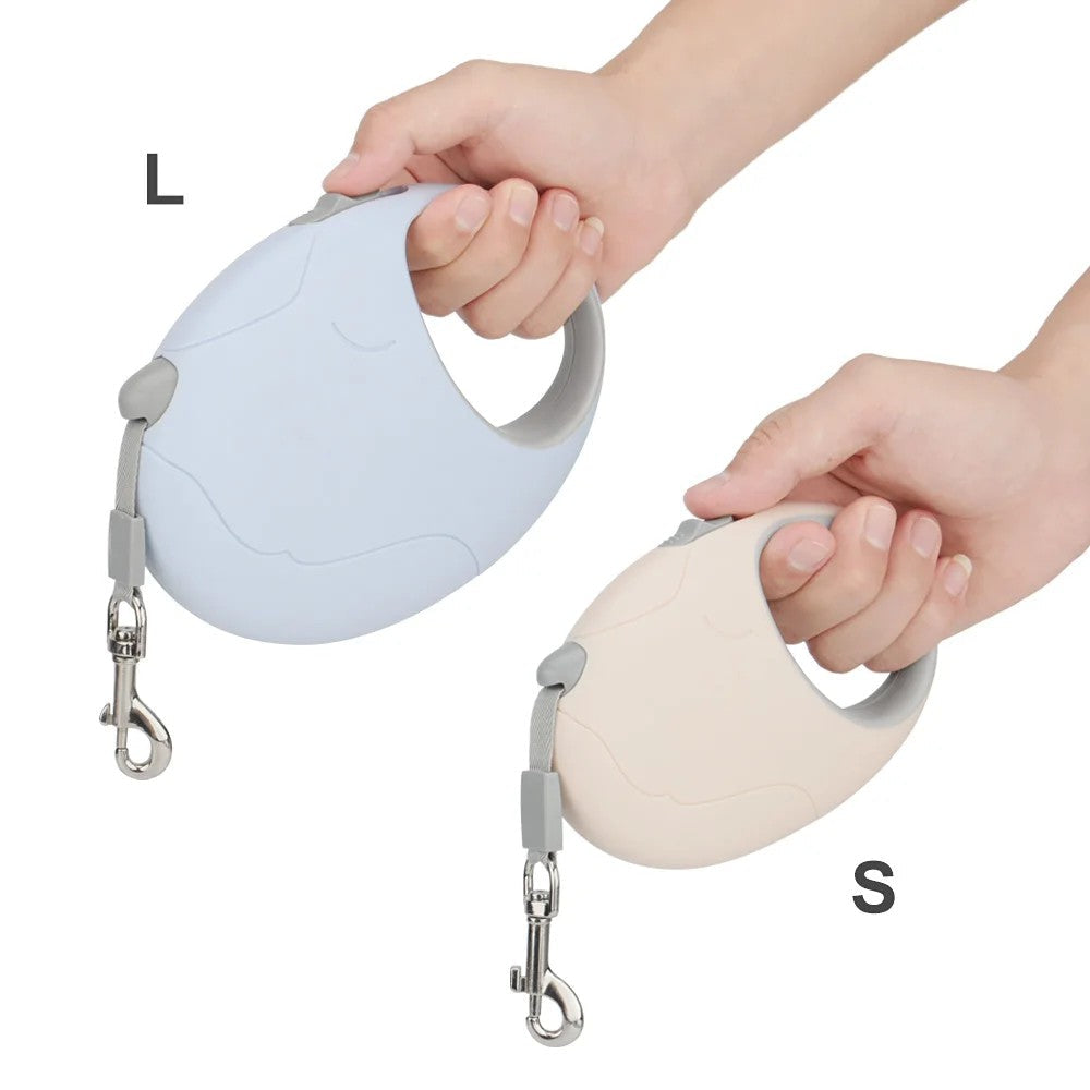 S and L retractable leashes held in the hand to show size