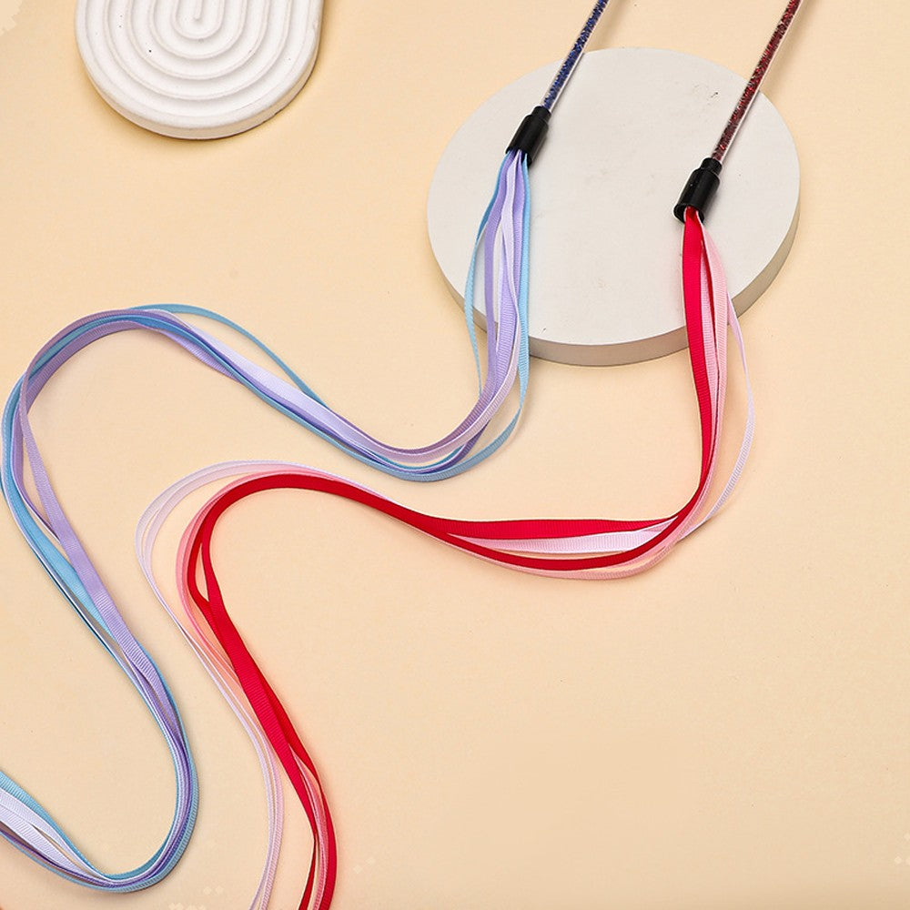 Red and blue cat ribbon wands lying on a table