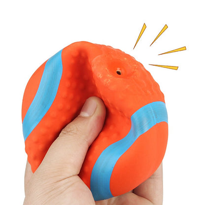 Hand squeezing the soft latex rugby ball to make it squeak