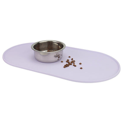 Purple silicone pet bowl mat catching spilled kibble around a steel bowl