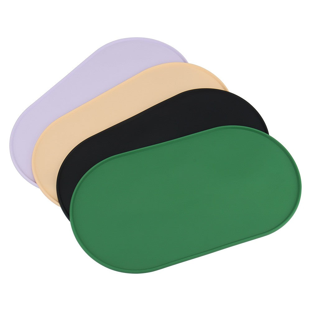 Silicone bowl mats stacked in purple, beige, black and green