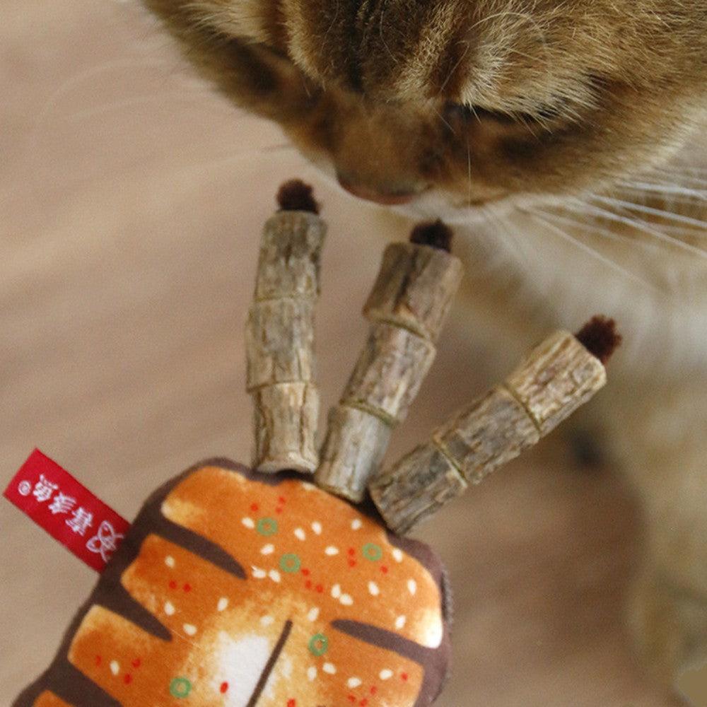 Cat sniffing and chewing the silvervine sticks on the squid toy