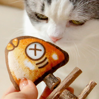 Cat nuzzling the cloth fish head of the chew toy