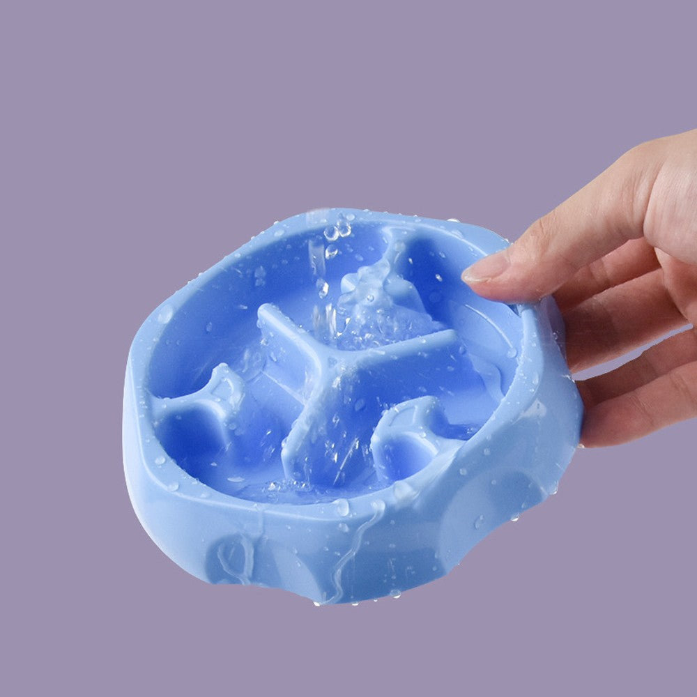 Hand rinsing the blue slow feeder bowl, showing the smooth easy-clean surface