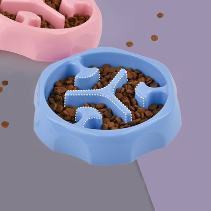 Blue round slow feeder dog bowl with kibble spread between the maze ridges
