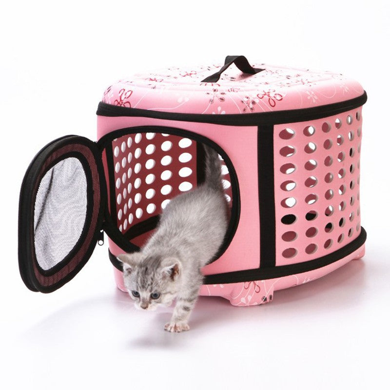 Small dog carrier in pink floral with a kitten stepping out of the mesh door