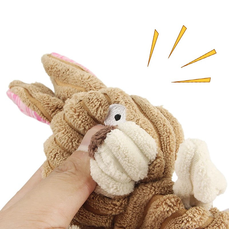 Hand pressing the tan rabbit toy to sound the squeaker