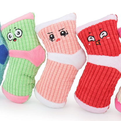 Close-up of three sock dog toys with cheeky faces