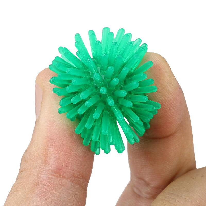 Green spiky ball held between fingers