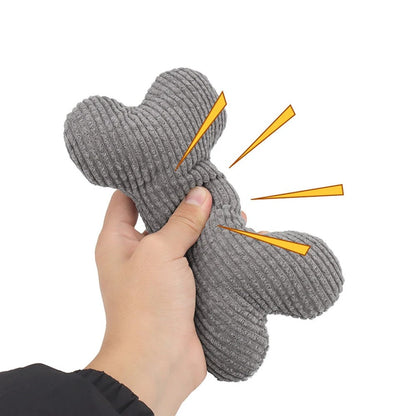 Hand squeezing the grey bone toy to sound the squeaker