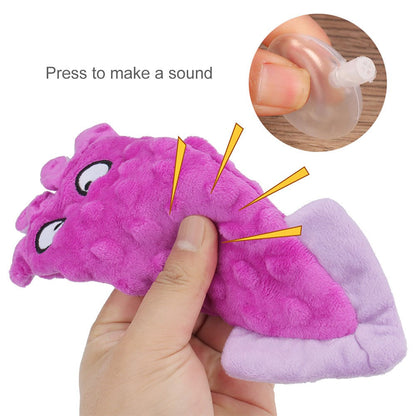Hand squeezing the plush squid dog toy to make it squeak