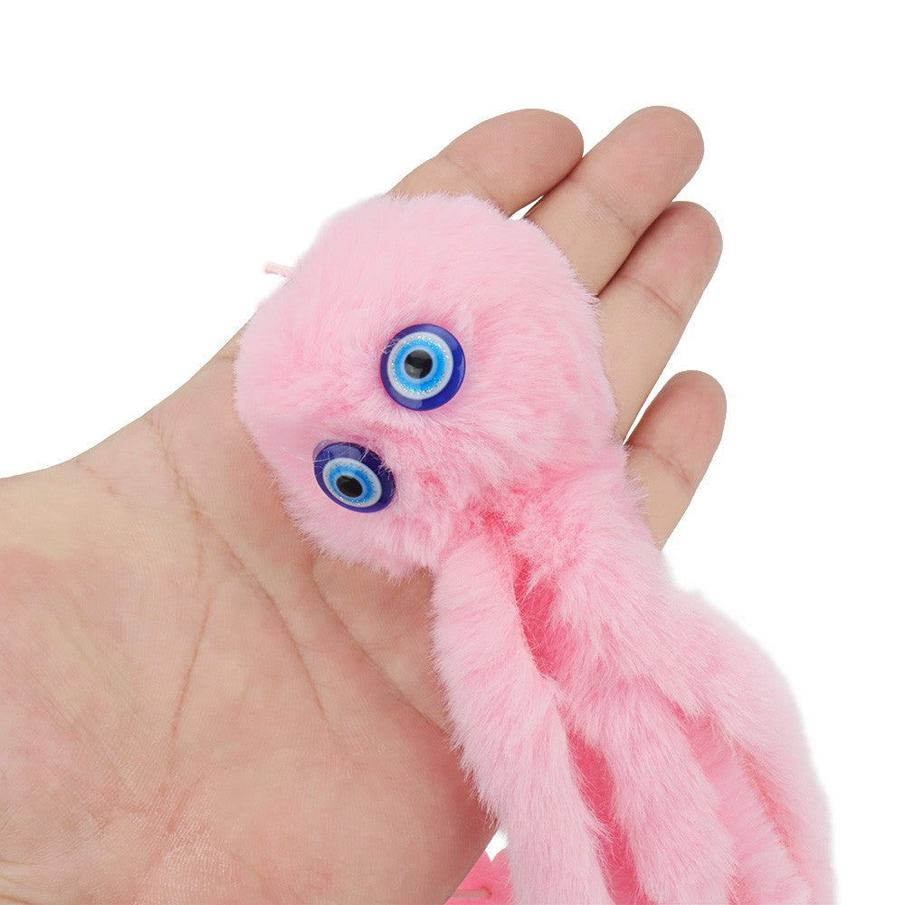 Pink octopus toy held in a hand to show the soft plush and eyes