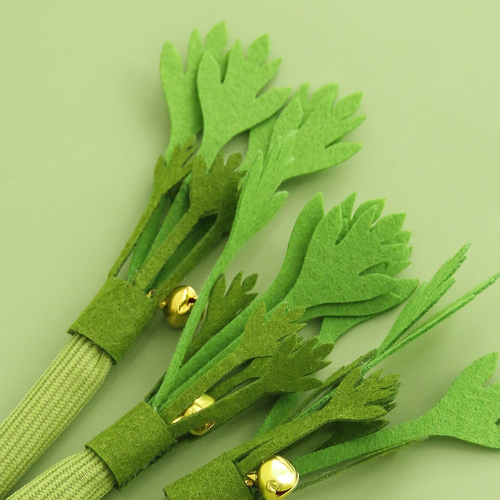 Close-up of the felt leaves and little bell