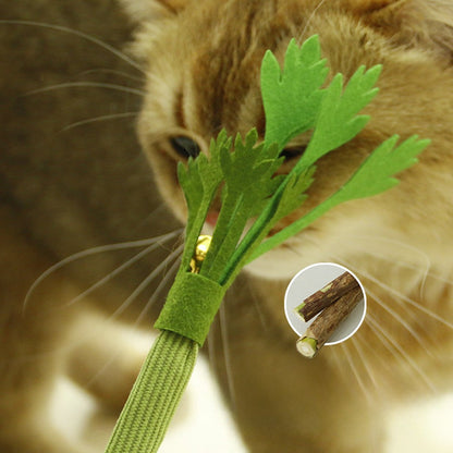 Ginger cat chewing the leaves of the celery toy