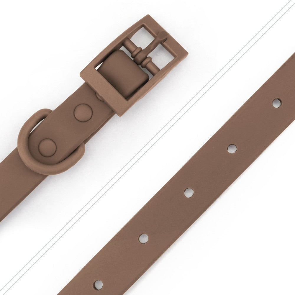 Close-up of the brown buckle and smooth PVC strap